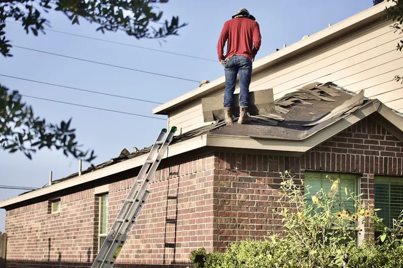 Professional roofer working on a residential roof in Mill Brook